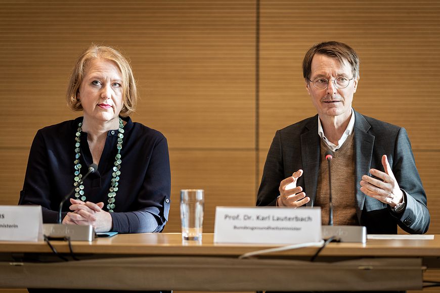 Bundesfamilienministerin Lisa Paus und Bundesgesundheitsminister Karl Lauterbach sitzen an einem Tisch in einer Pressekonferenz. 